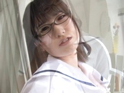 Schoolgirl with glasses gives a sensual striptease