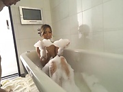 Adorable Aika Soggy licks erotically in a bathtub