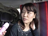 Japanese MILF plays with a vibrator in a van