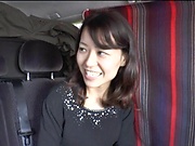 Brunette Japanese MILF gets pussy toyed in a van