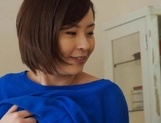 Busty Japanese mature babe teases cock with warm handjob picture 23