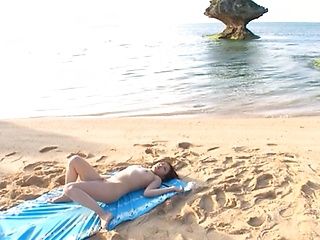 Kinky Japanese milf is fingered and fucked on a beach