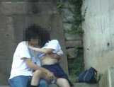 Asian sweetie and her guy having sex on the steps outside picture 11
