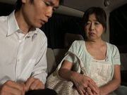 Mature Japanese AV model gives a hand job in the car