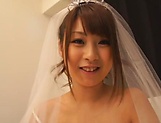 Gorgeous Asian bride seductively teases in her wedding dress